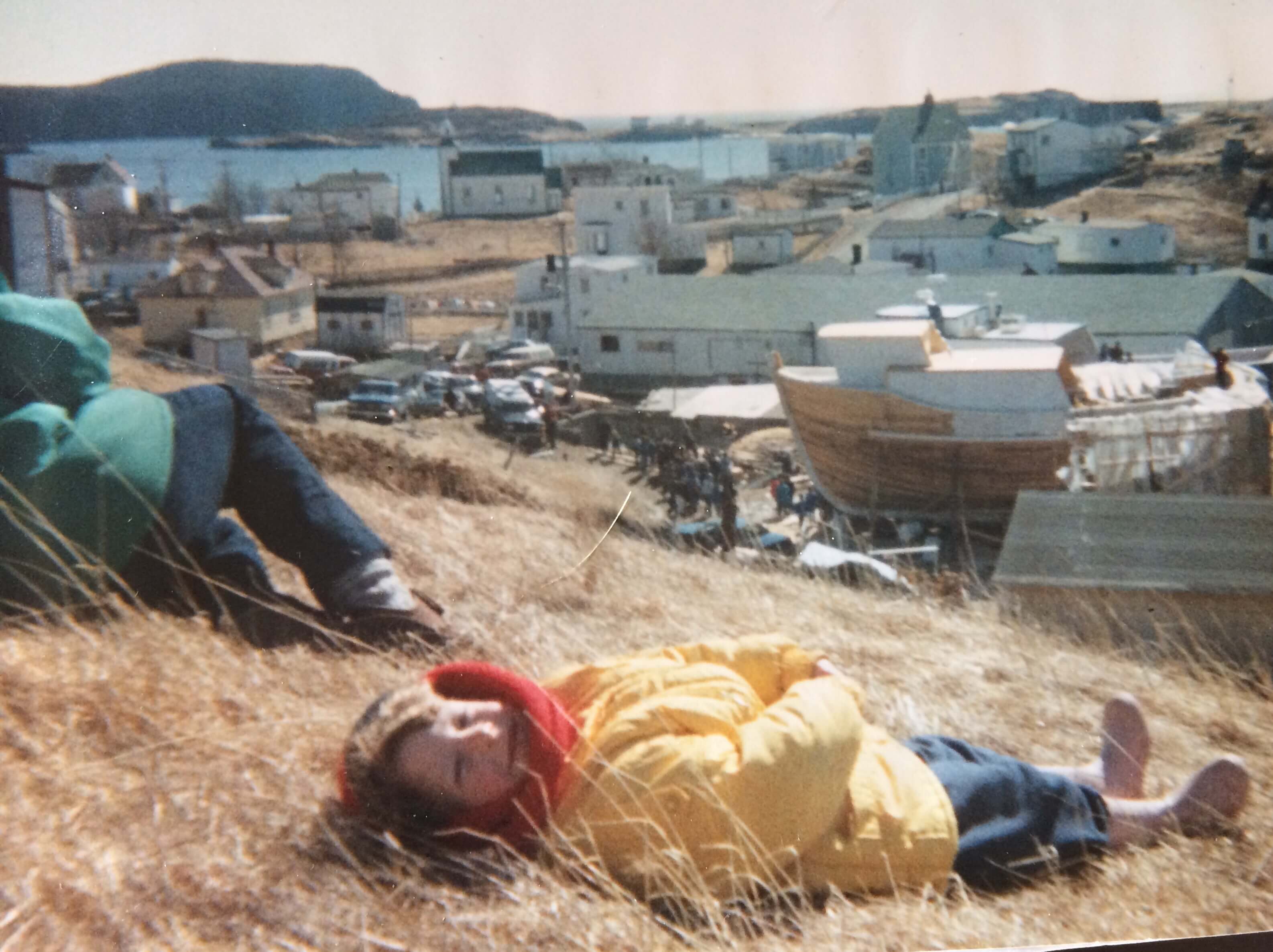 a young girl watching a fishing boat being built