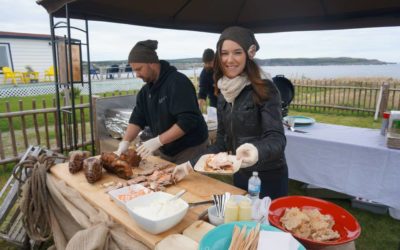 Woman serving food oceanside at Roots Rants and Roars